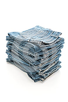 stack of jeans folded on white background