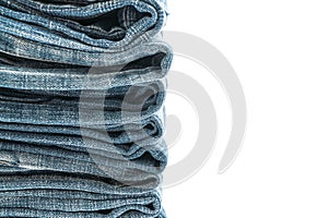 stack of jeans folded on white background