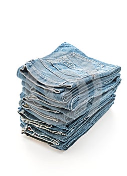 stack of jeans folded on white background