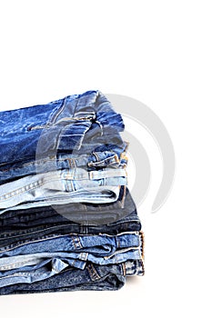 Stack of jeans pants on white background - Image