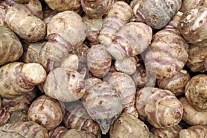 Stack of Jerusalem artichokes on a market stall
