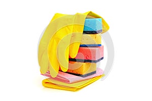 Stack of kitchen sponges, yellow rubber, household gloves and  surface cleaning wipes isolated on white background