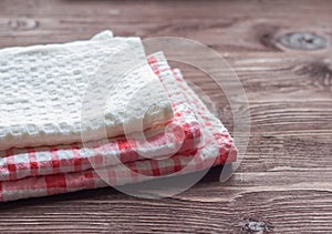 Stack of kitchen towels on wooden background
