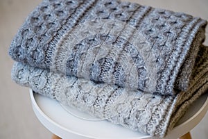 A stack of knitted handmade plaids