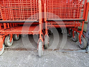 Stack of large red wire shopping carts