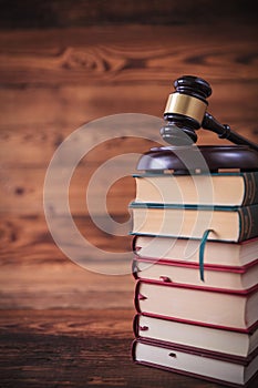 Stack of law books with judge`s gavel on top