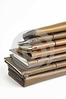A Stack Of Leather-Bound Journals, Notebooks, Wallets & Cases