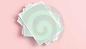 Stack of Light Green A4 Paper Sheets on a Soft Pink Background Layout