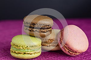 Stack of macaroons on pink jute tablecloth