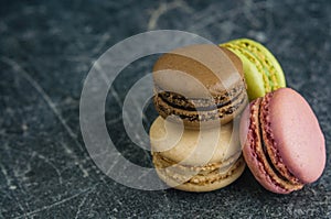 Stack of macaroons on a scratched old chalkboard background
