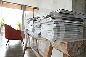 Stack of magazine book on wooden table shelf