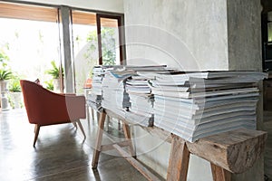 Stack of magazine book on wooden table shelf in living room