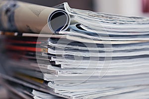 A stack of magazines, close-up macro filled the frame. A background for publishing or informational articles.