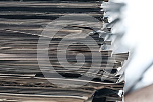 A stack of magazines, close-up macro filled the frame. A background for publishing or informational articles.