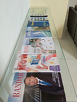 Stack of Magazines on Glass Table