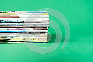 Stack magazines on green background