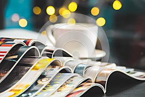 Stack Magazines place or Old books on black desk with coffee cup background. selective focus photo