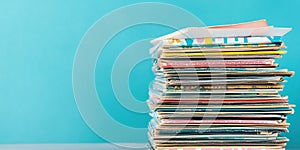 Stack of magazines on table with blue background