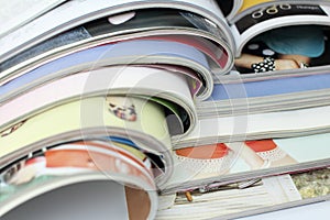 Stack of magazines on white background