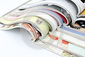Stack of magazines on white background