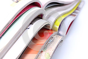 Stack of magazines on white background
