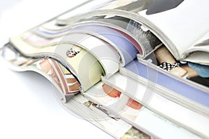 Stack of magazines on white background
