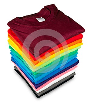 Stack of many fresh new fabric cotton  t-shirts in colorful rainbow colors isolated. Pile of various colored shirts  white