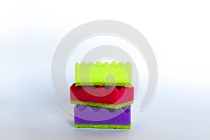 Stack of many multi-colored dish wash sponges. Household cleaning scrub pad. Home cleaning concept. Space for text