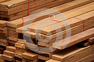 Stack of many wooden planks in construction site