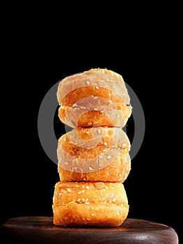 Stack of meat-flossed bread against a black background.