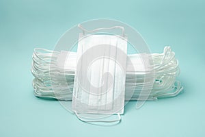 Stack of medical masks on the blue background
