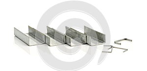 Stack of metal staples on a white