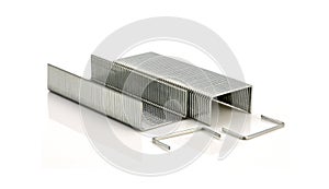 Stack of metal staples on white