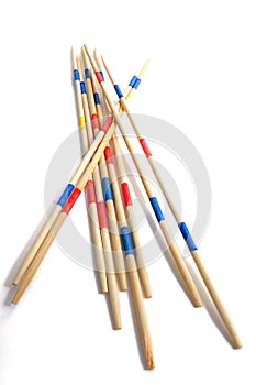 Stack of Mikado game wood sticks on white background.