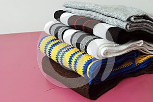 Stack of modern different colors winter woolen scarfs