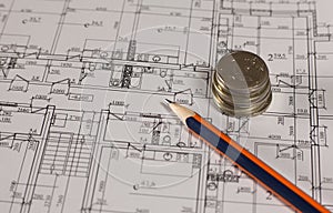 Stack of money coins with pencil