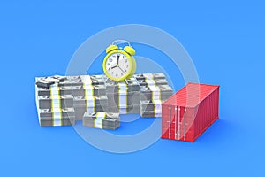 Stack of money near alarm clock, freight container photo