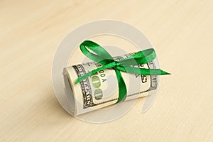 A stack of money with a ribbon. Expensive gift