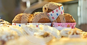 Stack of muffins arranged on tray at bakery