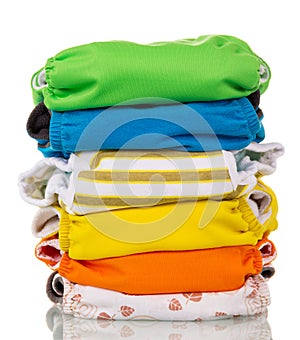 Stack of multi-colored modern eco-friendly diapers is isolated o