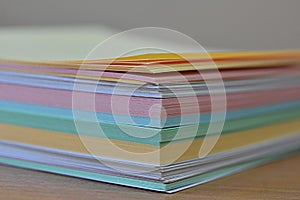 Stack of multi-colored stickers close-up. pastel paper
