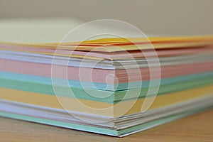 Stack of multi-colored stickers close-up. pastel paper