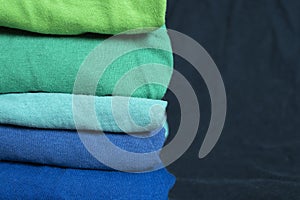 A stack of multicolored fabric in cool colors