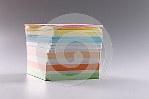 Stack of multicolored sticky notes on gray background