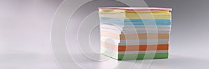 Stack of multicolored sticky notes on gray background