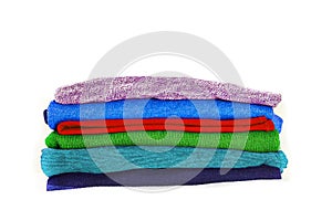 Stack of multicolored winter clothes isolated on white background