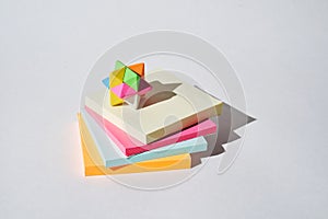 Stack of multicoloured paper stickers on a white background.