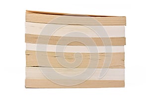 Stack of multiple old and yellowed stacked paperback books  on white background