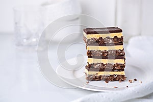 A stack of Nanaimo bars - a traditional Canadian dessert - in a white kitchen