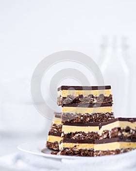 A stack of Nanaimo bars in a white kitchen